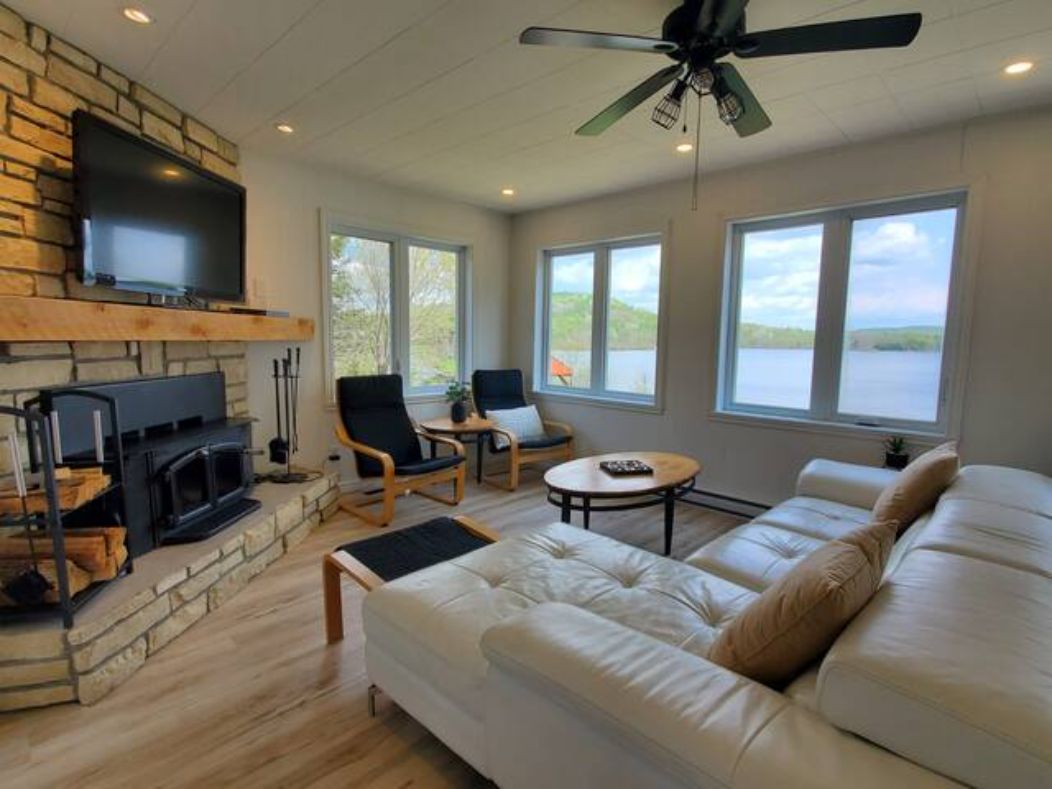 Warm living room with charming fireplace inside Chalet Nantel